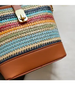 Detail of colorful hand-woven straw stripes with brown leather base and gold metal lock