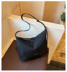 Close-up of CLEAROX minimalist black shoulder bag with durable zipper and nylon texture