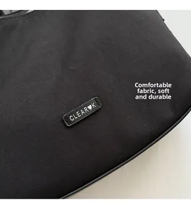 Close-up of CLEAR K logo on black tear-resistant nylon fabric with durable texture