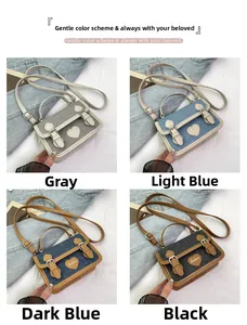 Detail view of denim crossbody bags in four colors with heart patches and buckle straps