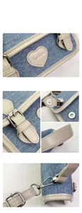 Detail view of denim handbag with heart embroidery, magnetic clasp, and leather trim