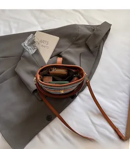 Top view of woven bucket bag interior showing capacity for phone, wallet and cosmetics
