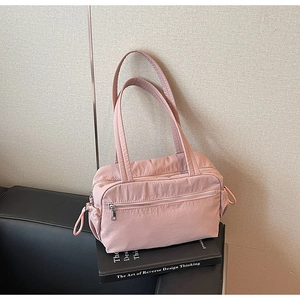 Detailed shot of pink versatile tote bag with side drawstrings and front zipper pocket