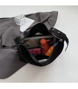 Interior view showing the spacious capacity of this black nylon shoulder tote bag