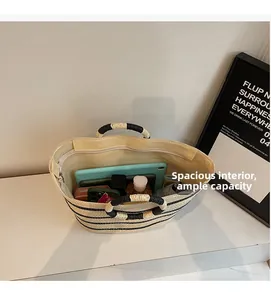 Spacious interior of woven stripe tote bag holding an iPad, umbrella and cosmetics