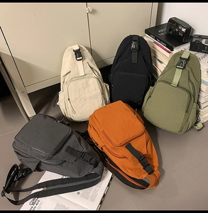 Selection of five nylon crossbody chest bags in diverse colors displayed in a lifestyle setting