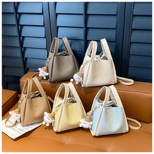 Close-up of minimalist bucket bags in five colors with lychee grain leather texture