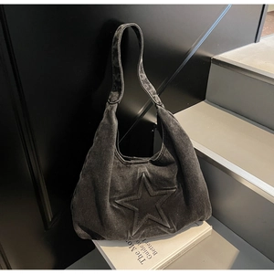 Detail shot of vintage washed denim tote bag with 3D star embossing and texture