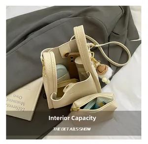 Interior view of the cream bucket bag showing high capacity for cosmetics and phone