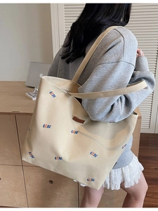 Large beige canvas tote bag with colorful QZBG embroidery and brown leather logo patch
