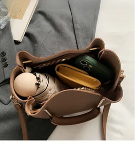 Internal view of brown litchi leather bucket bag showing capacity for daily essentials