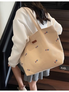 Large beige canvas tote bag with colorful embroidery and leather patch for women
