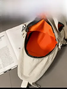 Internal capacity display of beige nylon crossbody bag with bright orange lining