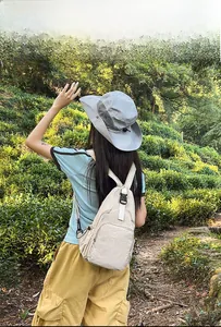 Model displaying a beige nylon multifunctional crossbody chest bag in an outdoor setting