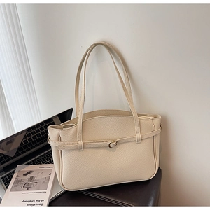Chic beige tote bag in lychee leather grain with dual handles and metal buckle detail