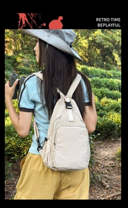 Outdoor lifestyle shot of a cream multi-functional nylon backpack with strap details
