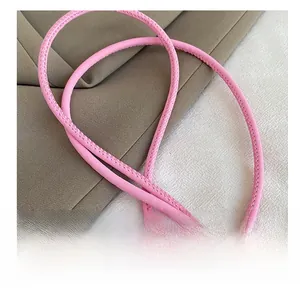 Detail showing high-quality pink leather shoulder strap with fine stitching for bags