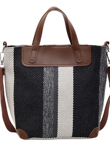 Striped woven tote bag with brown leather trim and adjustable crossbody shoulder strap