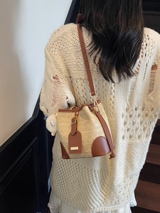 Women woven straw bucket bag with brown leather trim and cute plush charm pendant
