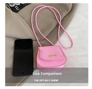 Pink lychee leather mini crossbody bag size comparison showing small compact scale