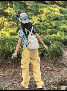 Outdoor view of beige waterproof nylon tactical backpack with adjustable buckles