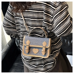 Detail of vintage denim crossbody bag showing the stylish size and on-body look for women