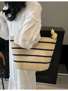 Large hand-woven straw tote bag with black stripes for summer beach vacations