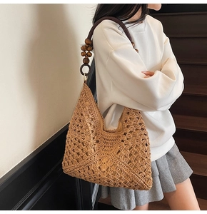 Detail of hand-woven tote bag showing vintage multi-layer wooden beads on shoulder strap