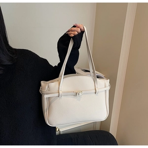 Close-up of cream white lychee pattern leather tote bag with elegant buckle detail