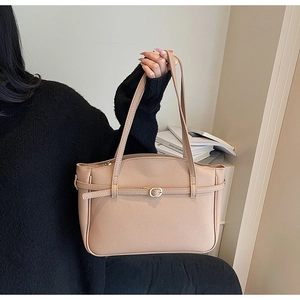 Detail of nude lychee pattern leather tote bag showing fine texture and metal buckle