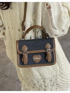Blue denim crossbody bag with brown leather trim and heart fashion patch detail