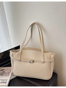 Chic cream leather tote bag with pebble texture and wavy edge for office commute