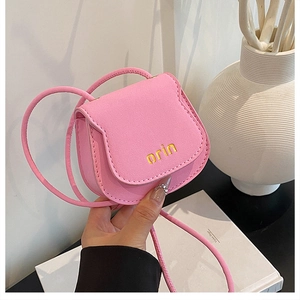 Detailed close-up of a mini pink saddle bag with yellow orin embroidery and magnetic flap