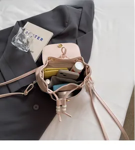 Top view of pink drawstring bucket bag showing spacious interior with pockets