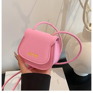 Pink lychee grain leather mini saddle bag with embroidered logo and flap closure detail