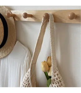 Detail of hollow knit texture on a cream shoulder bag with soft inner lining and wide strap