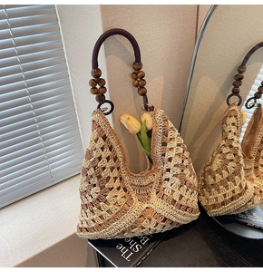 Close-up of woven tote bag with contrast stitching and wooden bead handle details