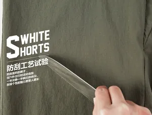 Close-up of olive green outdoor shorts showing durable scratch-resistant fabric texture
