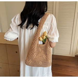 Detail of hollow woven cotton shoulder bag with bohemian texture for beach or vacation