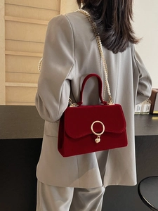 Elegant red velvet crossbody bag with gold heart clasp and pearl chain strap for women