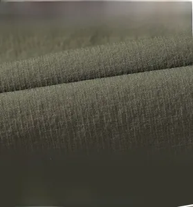 Detail of army green ripstop fabric with breathable and tear-resistant outdoor texture