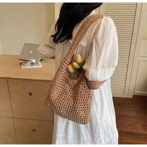 Detailed close-up of brown crochet woven shoulder bag with natural cotton texture