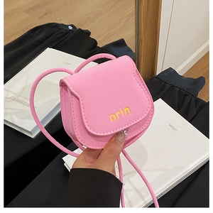 Detail of pink mini saddle bag with yellow orin embroidery and leather shoulder strap