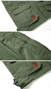 Detail of olive green fishing vest showing multi-pocket design and breathable mesh lining