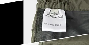 Detail of wash label and stitching on quick-dry shorts with nylon fabric texture