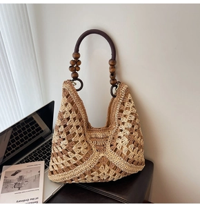 Close-up of woven straw tote bag featuring geometric textures and dark wooden bead handles