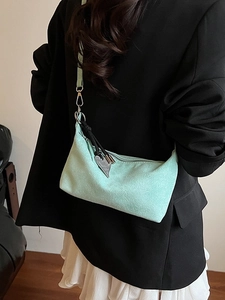 Chic mint green suede underarm bag with heart tassel pendant for stylish women
