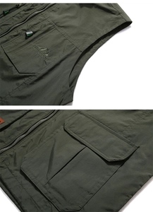 Detail of army green outdoor vest featuring embroidery and functional zipper pockets