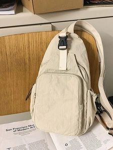 Versatile beige nylon crossbody chest bag with adjustable strap and multiple pockets