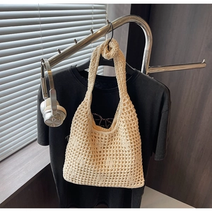 Detailed macro view of the cream woven cotton shoulder bag with openwork crochet patterns